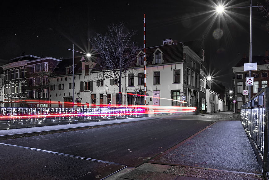 Night long exposure of train crossing bridge in European city