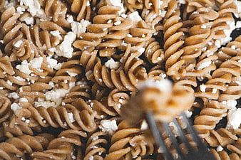 Close-up of whole wheat fusilli pasta with feta cheese