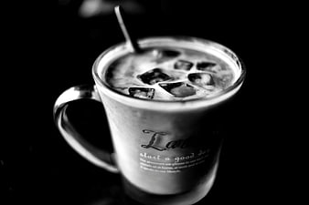 Black and white iced coffee in glass mug with text