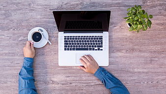 Top View of Hands Working on Laptop with Coffee