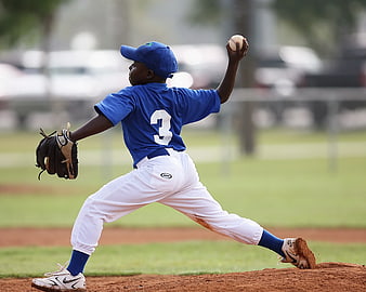 Young Baseball Pitcher in Blue Jersey Throwing Ball