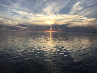 Serene Sunset Over Calm Lake with Golden Reflections