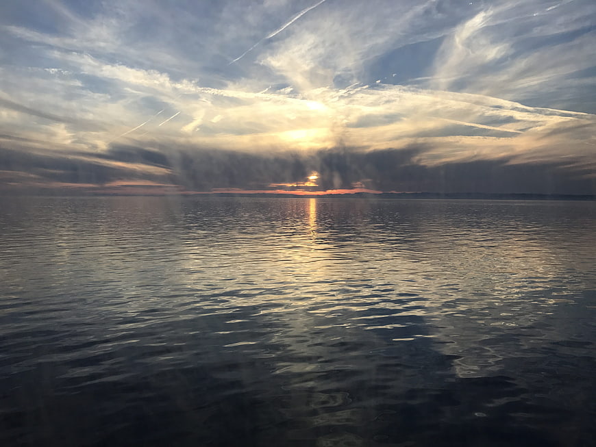 Serene Sunset Over Calm Lake with Golden Reflections