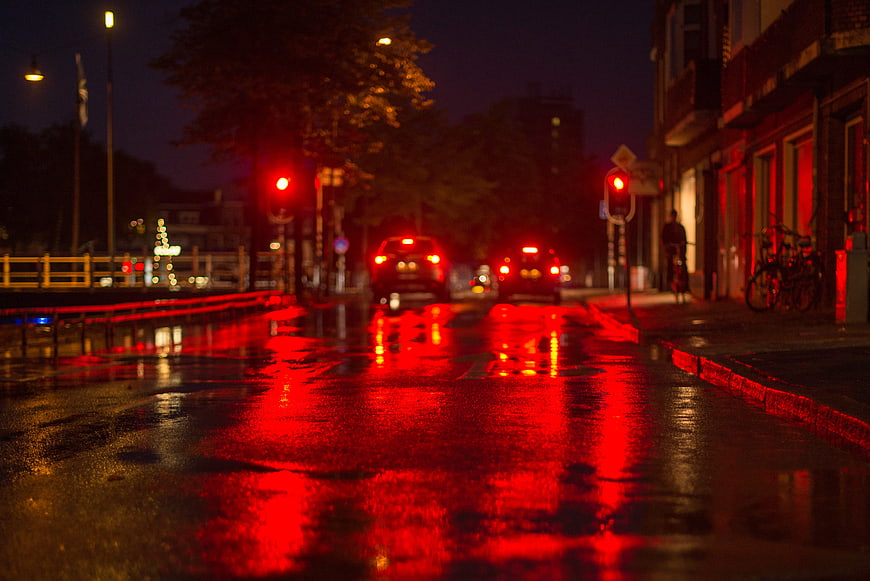 Red Traffic Lights Reflecting on Wet City Street at Night