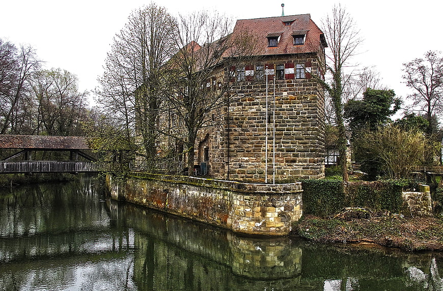 Historic stone castle with moat and wooden bridge in Bavaria