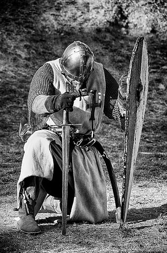 Medieval Knight Kneeling with Sword and Shield in Black and White
