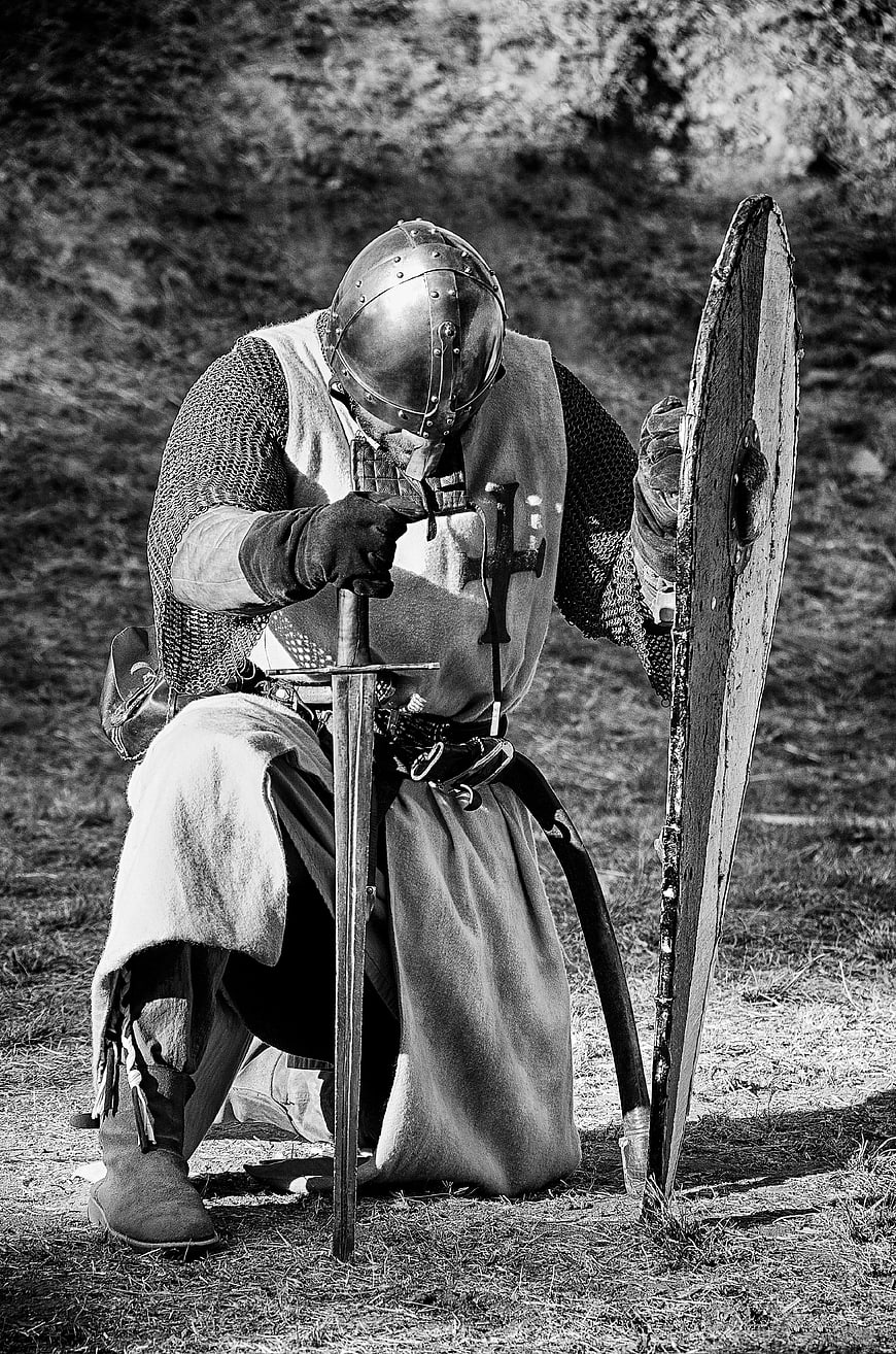 Medieval Knight Kneeling with Sword and Shield in Black and White