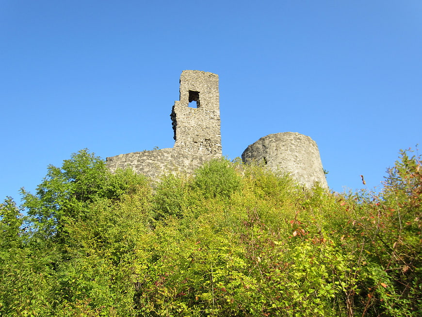 Ancient stone castle ruins on a hill with blue sky