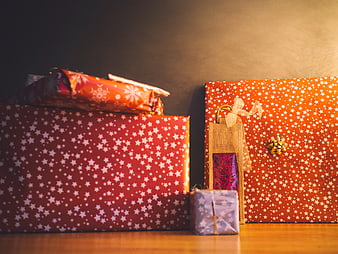 Festive Christmas Gifts Wrapped in Red and Orange Star Paper