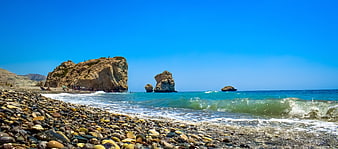 Petra tou Romiou coastal landscape with Aphrodite's Rock and pebble beach