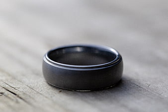 Matte Black Wedding Band on Rustic Wood Surface
