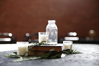 Rustic Table Centerpiece with Glass Bottle, Candles, and Books