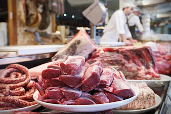 Fresh raw meat and sausages in a butcher shop display