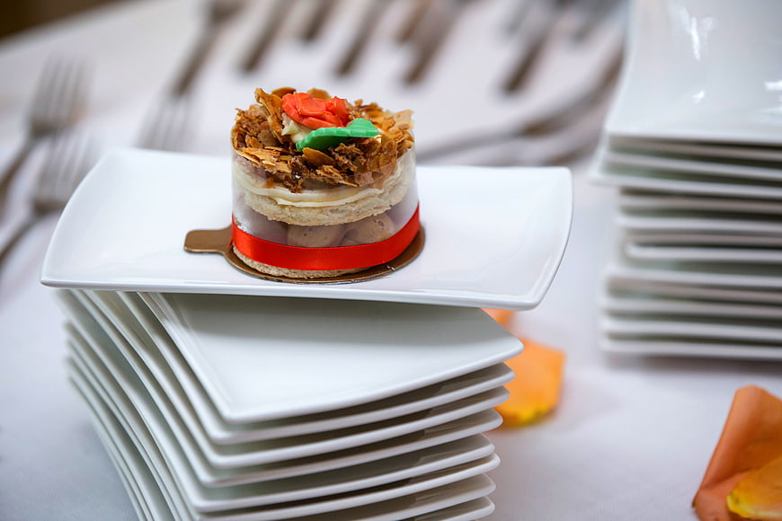 Mini layered dessert cake on white square plate stack