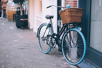 Vintage Bicycle with Wicker Basket on Cobblestone Street