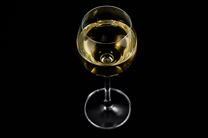 Top View of White Wine Glass on Black Background