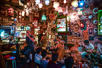 Colorful eclectic ruin bar interior with people drinking