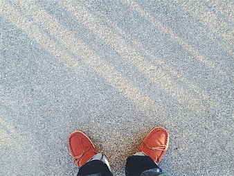 Top View of Orange Moccasins on Concrete Pavement