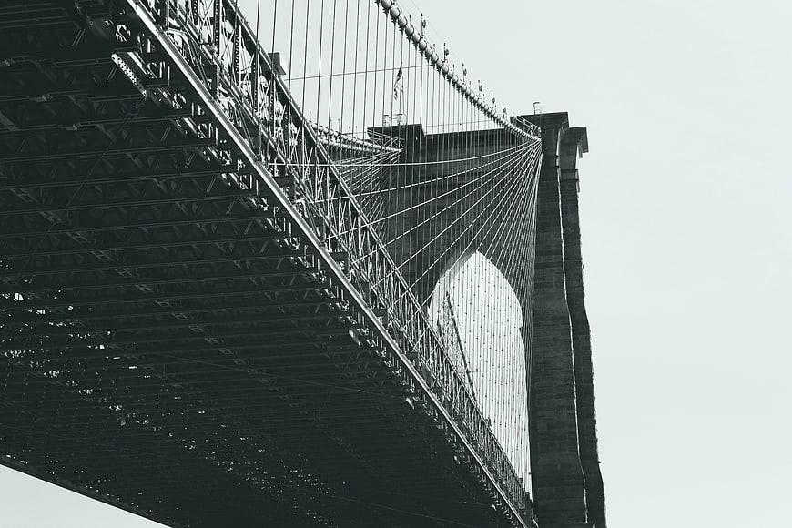 Low angle view of Brooklyn Bridge steel structure and cables