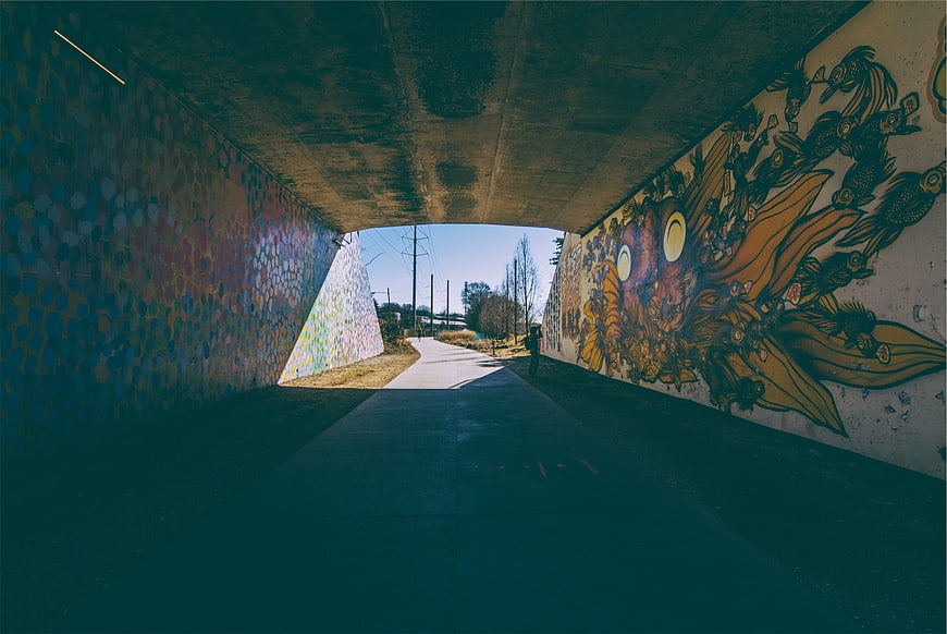 Colorful Graffiti Tunnel with Vibrant Murals and Pathway