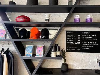 Modern Coffee Shop Interior with Merchandise and Menu