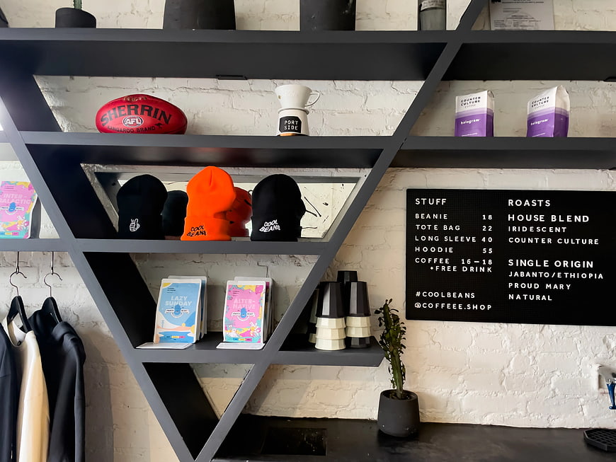 Modern Coffee Shop Interior with Merchandise and Menu
