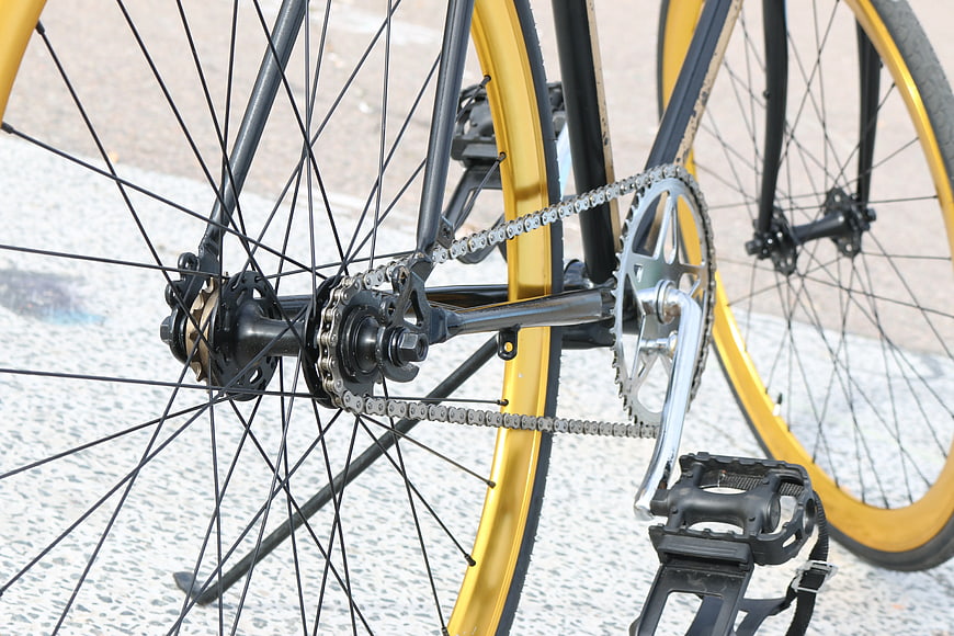 Close-up of yellow bicycle gears and chain mechanism