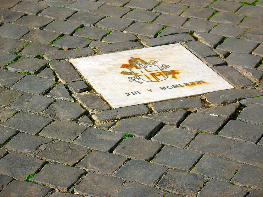 Pope John Paul II Memorial Tile on Cobblestone Street