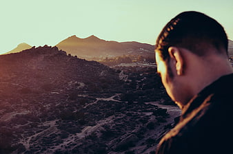Man Looking at Mountain Landscape at Sunset