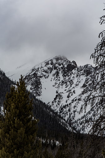 Snowy Mountain Peak Obscured by Clouds and Mist