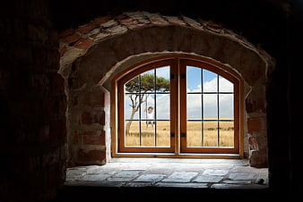 Child on Swing Viewed Through Arched Stone Window