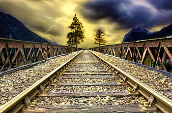Dramatic HDR Railway Tracks on Bridge with Lightning Storm