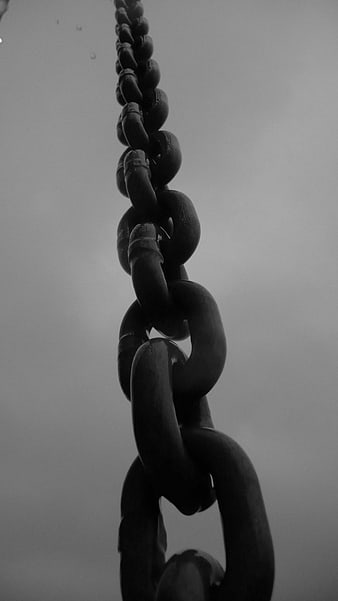 Black and white close-up of a heavy industrial metal chain link
