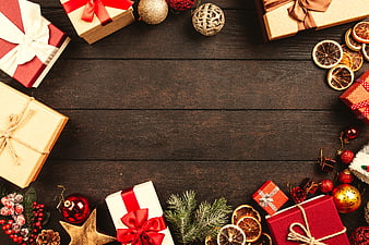 Christmas gifts and decorations on dark wood background