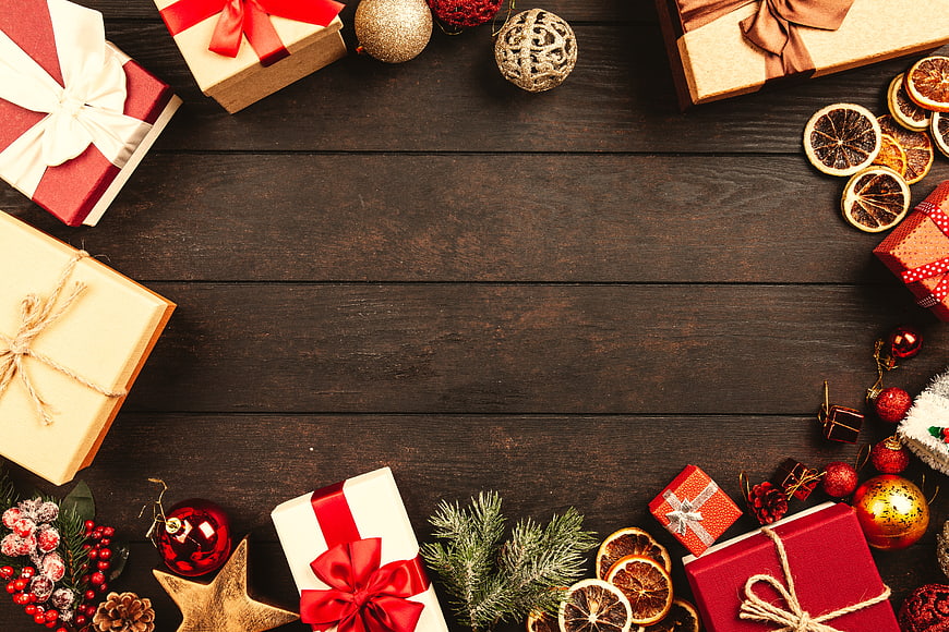 Christmas gifts and decorations on dark wood background