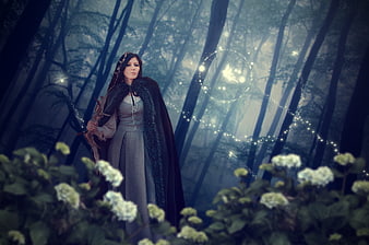 Mystical Woman in Dark Forest with Magical Light Effects
