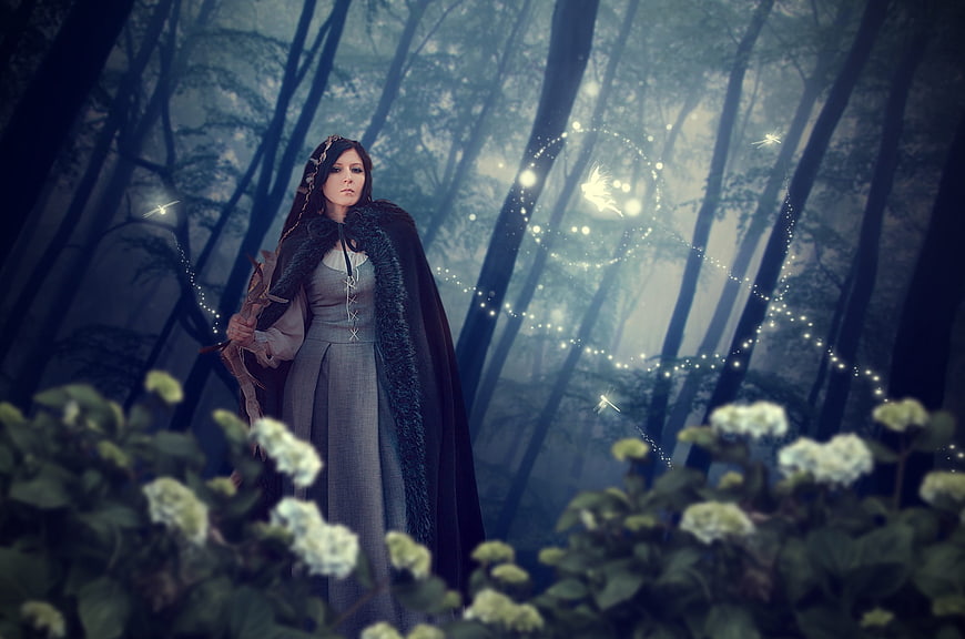 Mystical Woman in Dark Forest with Magical Light Effects