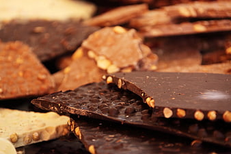 Close-up of assorted broken chocolate bars with nuts