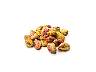 Pile of shelled pistachio nuts on white background