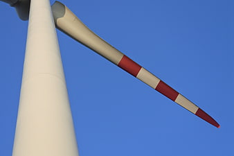 Low angle view of wind turbine blade against blue sky