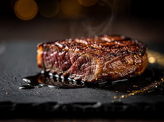 Sizzling Grilled Steak on Slate with Steam and Bokeh