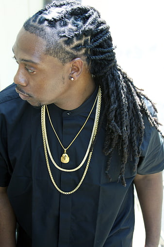 Portrait of Black Man with Braids and Gold Chains