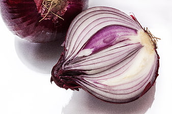Red Onion Cut in Half Showing Layers on White Background