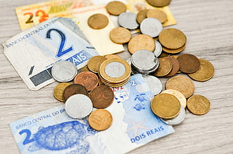 Brazilian Real Banknotes and Coins on Wooden Table