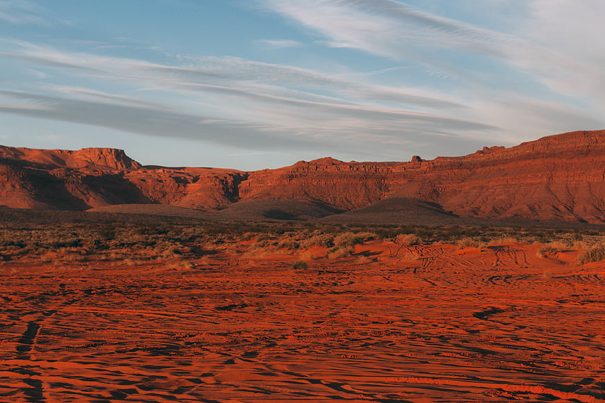 Red Desert Landscape with Sand Dunes and Rock Formations