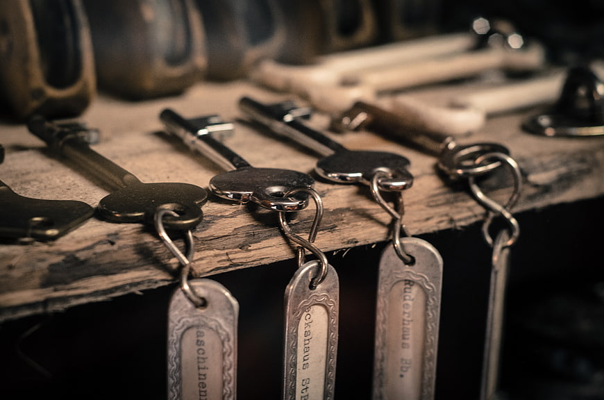 Vintage metal keys with tags on rustic wooden shelf