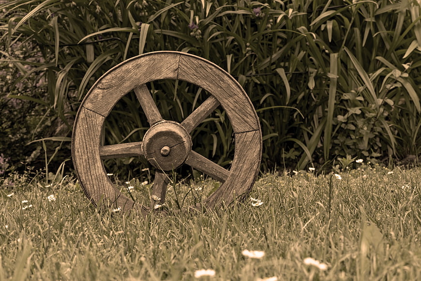 Vintage Wooden Wheel in Grassy Garden