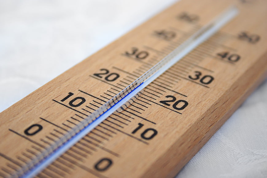 Close-up of wooden thermometer showing temperature measurement