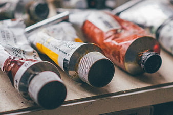 Close-up of used oil paint tubes on artist palette