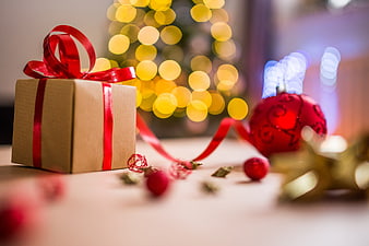 Christmas Gift Box with Red Ribbon and Bokeh Lights